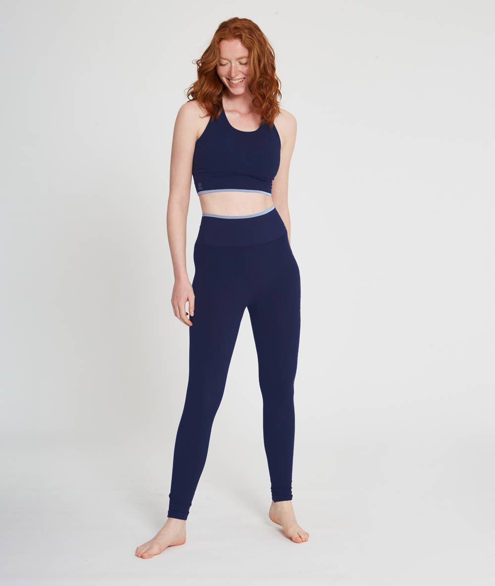 Women wearing navy blue bamboo leggings and longline sports bra that are soft moisture wicking