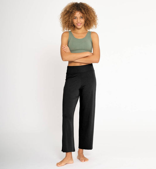 Women wearing black flared cut lyocell fabric yoga pants 